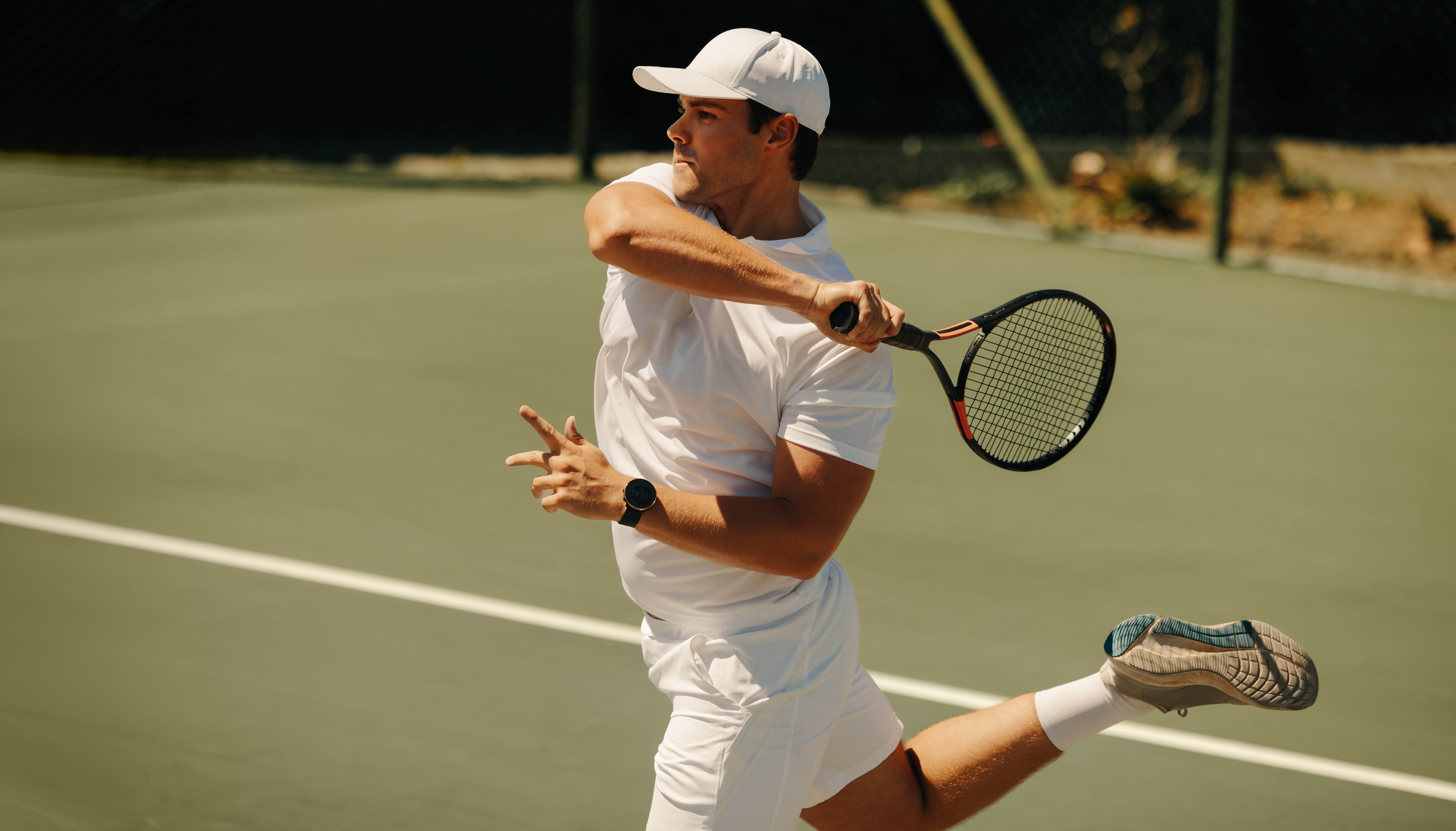 Man jumping while serving on the tennis court Man jumping while serving on the tennis court